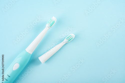 An electric toothbrush on a blue background