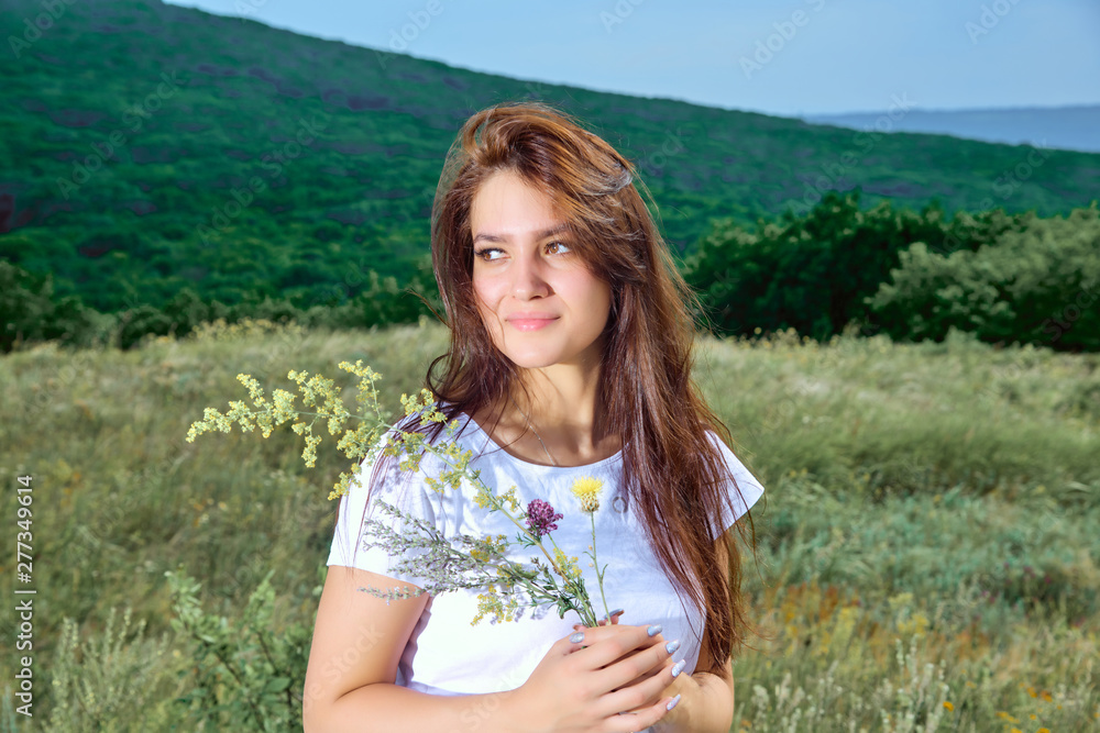 Girl in cowboy dress standing back on the top of Caucasus mountain.