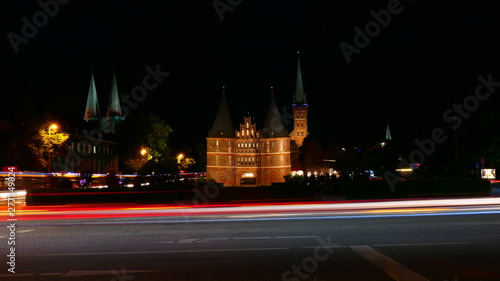 The famous Holsten Gate with night traffic blur in Lubeck, Germany