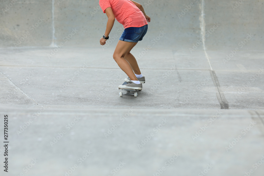 Fototapeta premium Female skateboarder skateboarding at skatepark