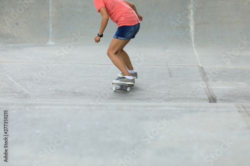 Female skateboarder skateboarding at skatepark © lzf