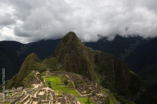 Machu Picchu city is illuminated by the sun through the clouds. city of the Incas. One of the New Seven Wonders of the World