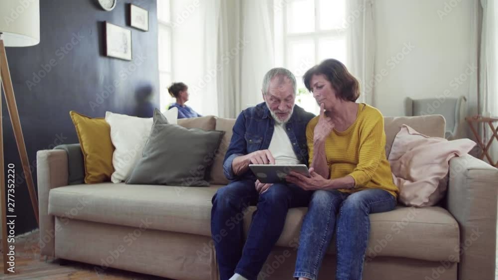 Senior couple using tablet in community center club. Senior couple using tablet in community center club.