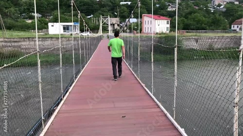 man walking by bridge in borjomi georigia travel concept photo