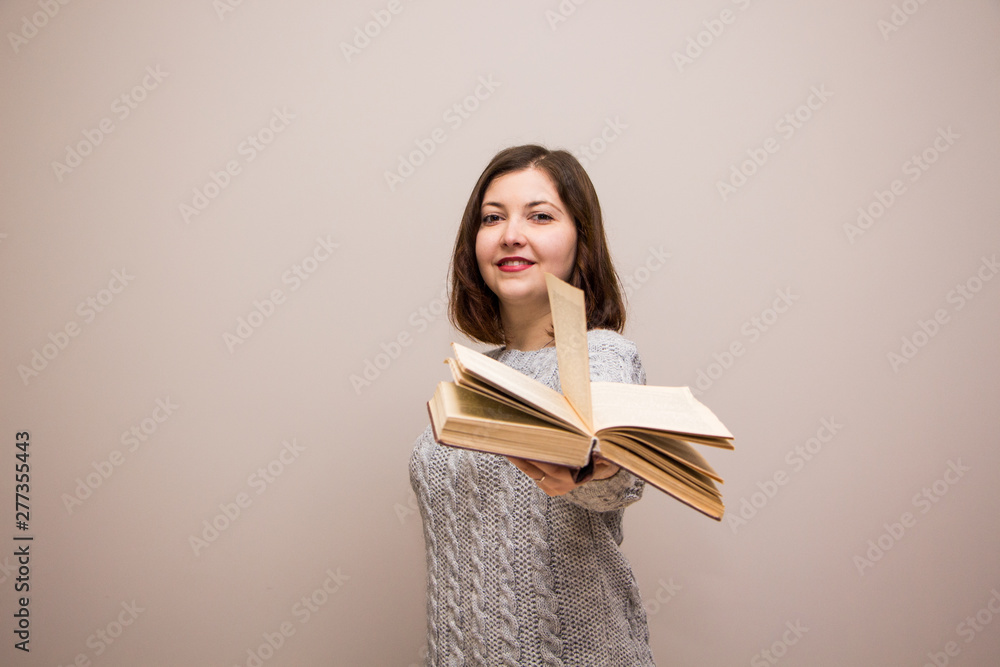 Portrait of young brunette woman with book in her hand Portrait of young brunette woman with book in her hand
