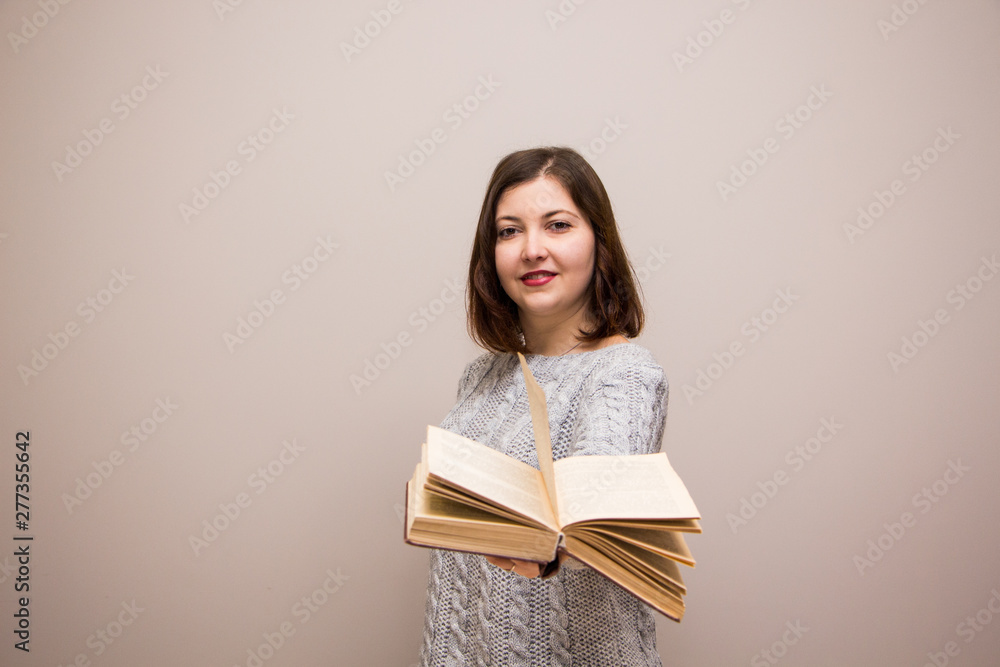 Portrait of young brunette woman with book in her hand Portrait of young brunette woman with book in her hand