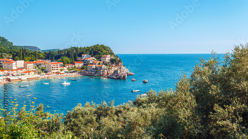 Picturesque summer view of Adriatic sea coast in Budva Riviera. Przno village with buildings on the rock, Montenegro