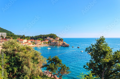 Fototapeta Naklejka Na Ścianę i Meble -  Picturesque summer view of Adriatic sea coast in Budva Riviera. Przno village with buildings on the rock, Montenegro