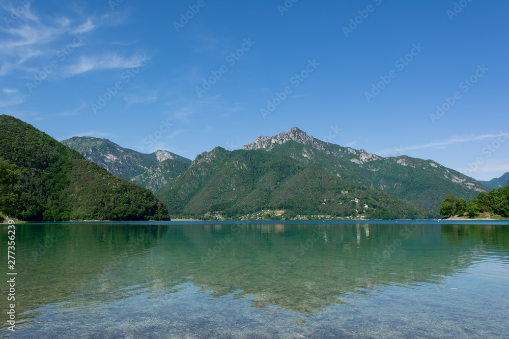 Beautiful view of mountain reflections in the water of Lago Di Ledro, Italy