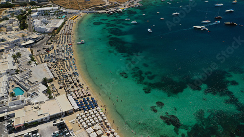 Aerial drone photo of paradise celebrity bay of Ornos famous for pool resorts and sandy turquoise organised clear sea beach, Mykonos island, Cyclades, Greece