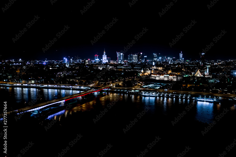 Night city skyline background. Aerial view of Warsaw capital city of Poland. From above, night city view with night sky. Night panorama of Warsaw cityscape. Aerial View