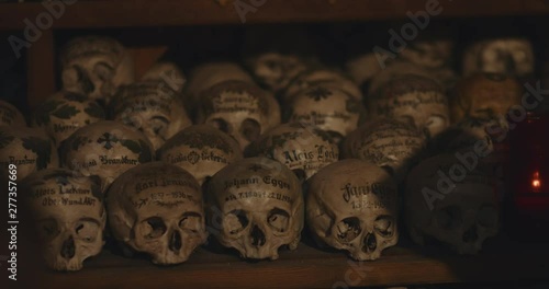 Skulls painted with names, flowers and crosses in the Beinhaus of Hallstatt. photo