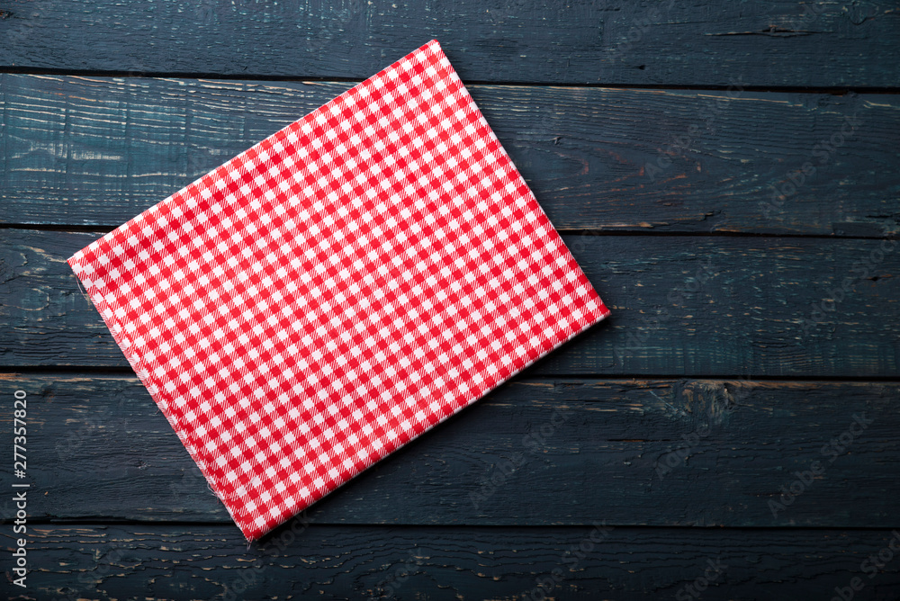 Obraz premium Empty wooden deck table and red checked tablecloth over mint wallpaper background