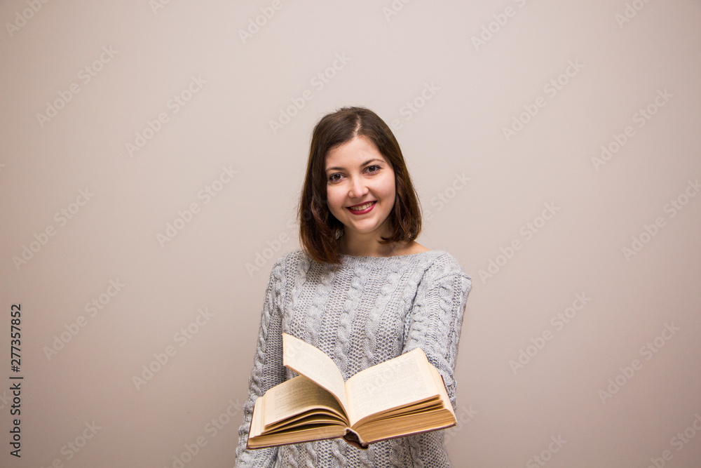Portrait of young brunette woman with book in her hand Portrait of young brunette woman with book in her hand