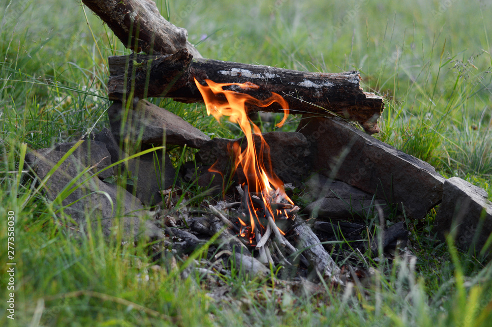 Cooking in a pot over campfire.Sunlight.Mountains. Cooking in a pot over campfire.Sunlight.Mountains.