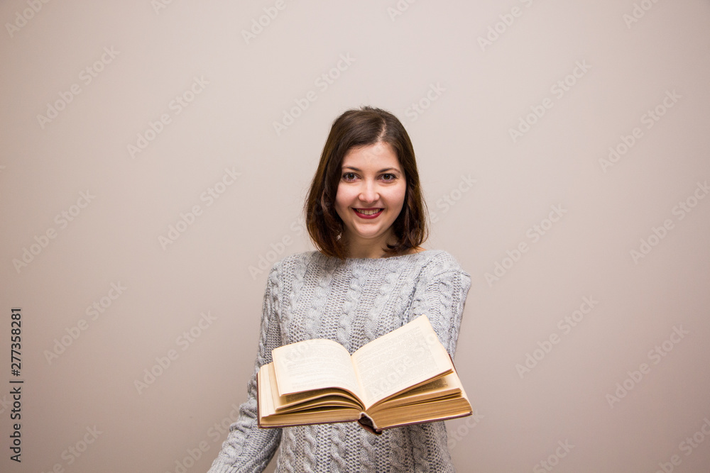 Portrait of young brunette woman with book in her hand Portrait of young brunette woman with book in her hand