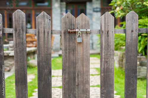 Obraz na plátně A closed gate of wooden fence of backyard garden