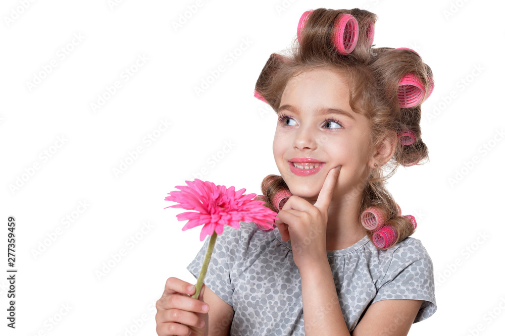 Portrait of little pretty girl with hair curlers posing with flower isolated - obrazy, fototapety, plakaty 