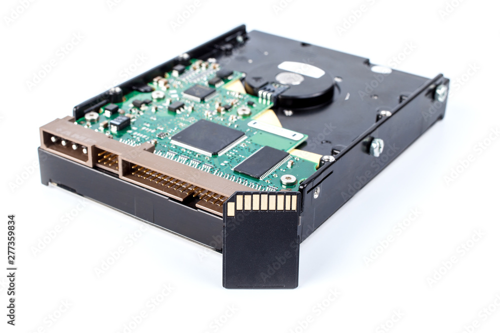 old hard drive near modern sd memory card on white background, close up. replacement with new technologies old hard drive near modern sd memory card on white background, close up. replacement with new technologies