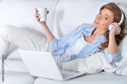 Portrait of young beautiful woman using laptop