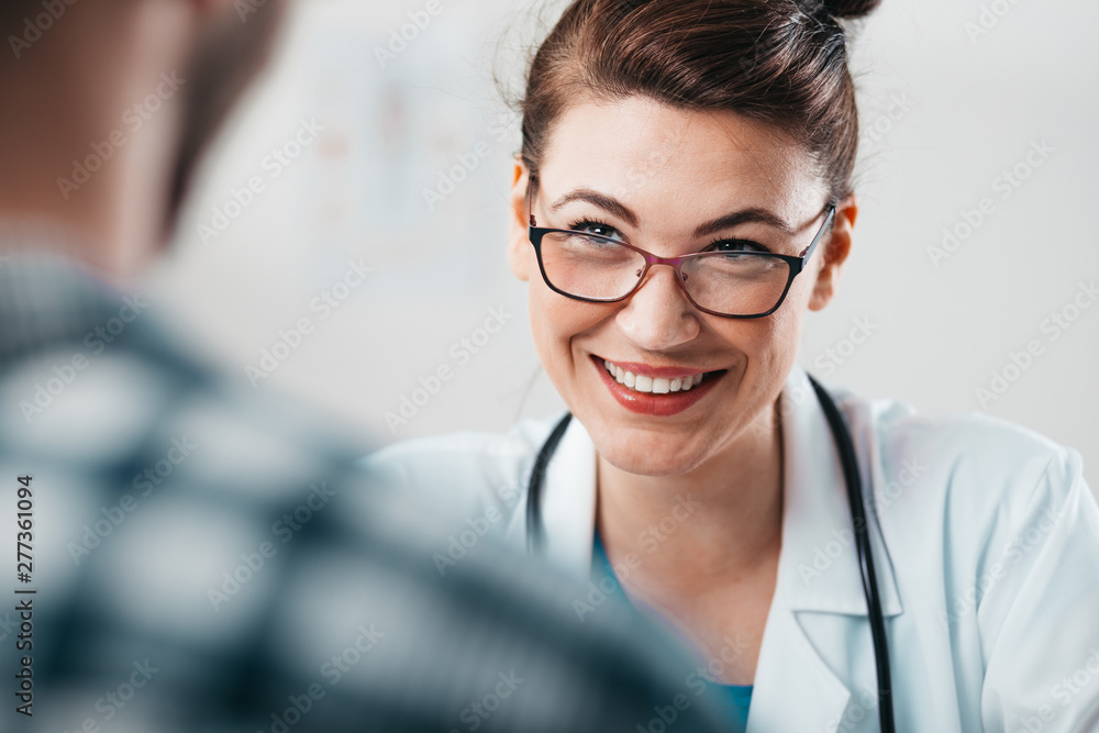 Woman Doctor prescribes medicine to Young Patient Woman Doctor prescribes medicine to Young Patient