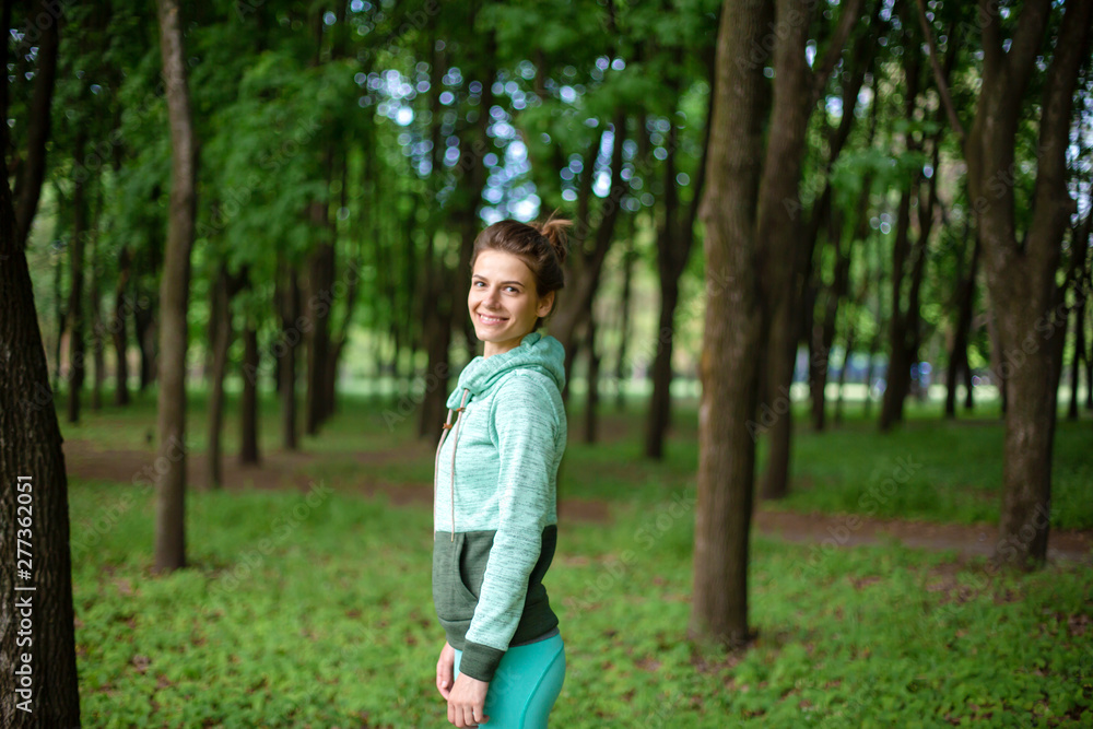 Thin brunette girl plays sports and performs beautiful and sophisticated yoga poses in a summer park. Green lush forest on the background. Woman doing exercises on a yoga mat Thin brunette girl plays sports and performs beautiful and sophisticated yoga poses in a summer park. Green lush forest on the background. Woman doing exercises on a yoga mat