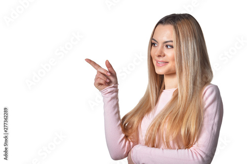 Portrait of beautiful woman pointing isolated on white background