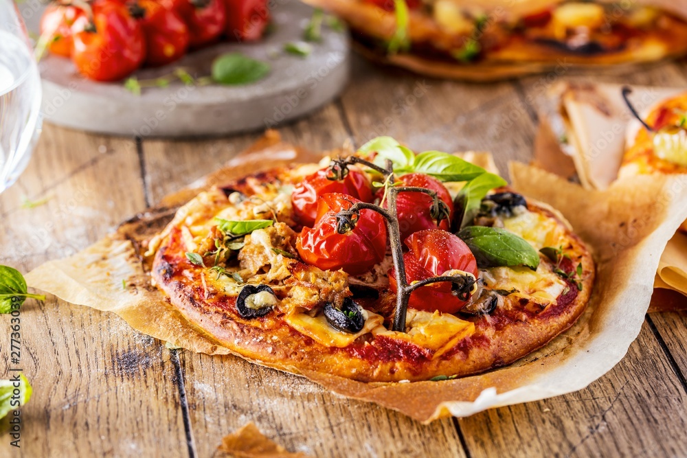 top view of delicious pizza with tomatoes on wooden table top view of delicious pizza with tomatoes on wooden table