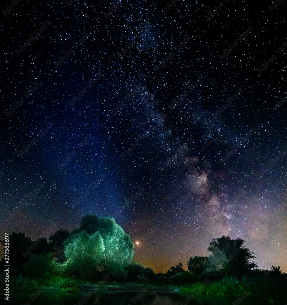 Starry sky and the milky way over water and trees. Starry sky and the milky way over water and trees.