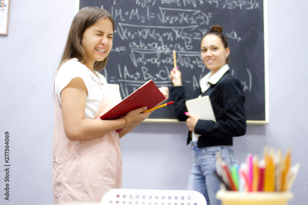 Student and teacher at the school board. The student did not learn homework Student and teacher at the school board. The student did not learn homework
