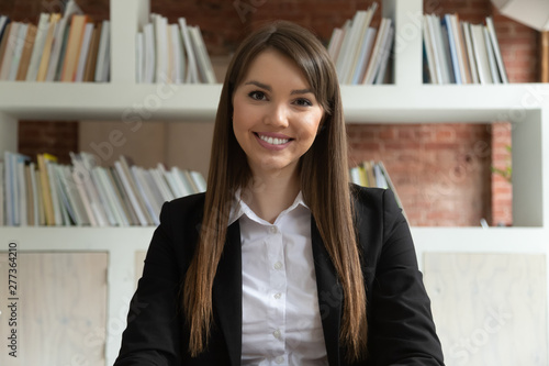 Smiling young businesswoman teacher looking at camera at job interview