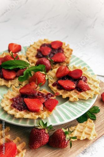 Viennese waffles with strawberries on a gray background. food photography