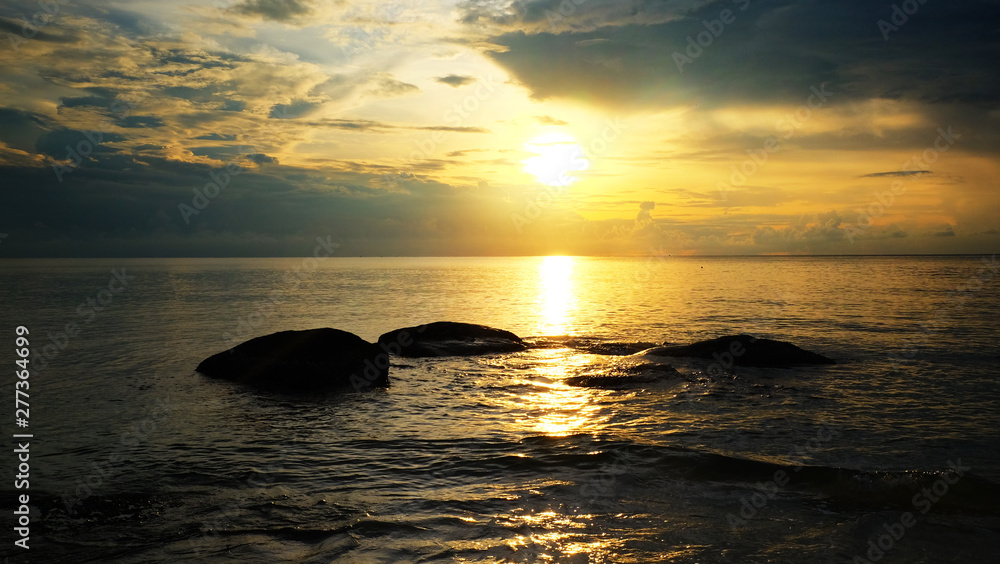 Sand beach with reef and sunrise sky on the morning.