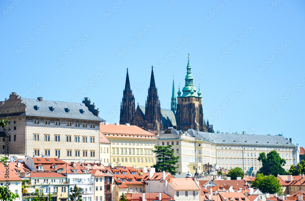 Fototapeta premium Amazing view of Prague Castle and St. Vitus Cathedral in Prague, Czech Republic photographed on a clear day with historical buildings around the castle. Czech capital, tourist place. Bohemia, Czechia