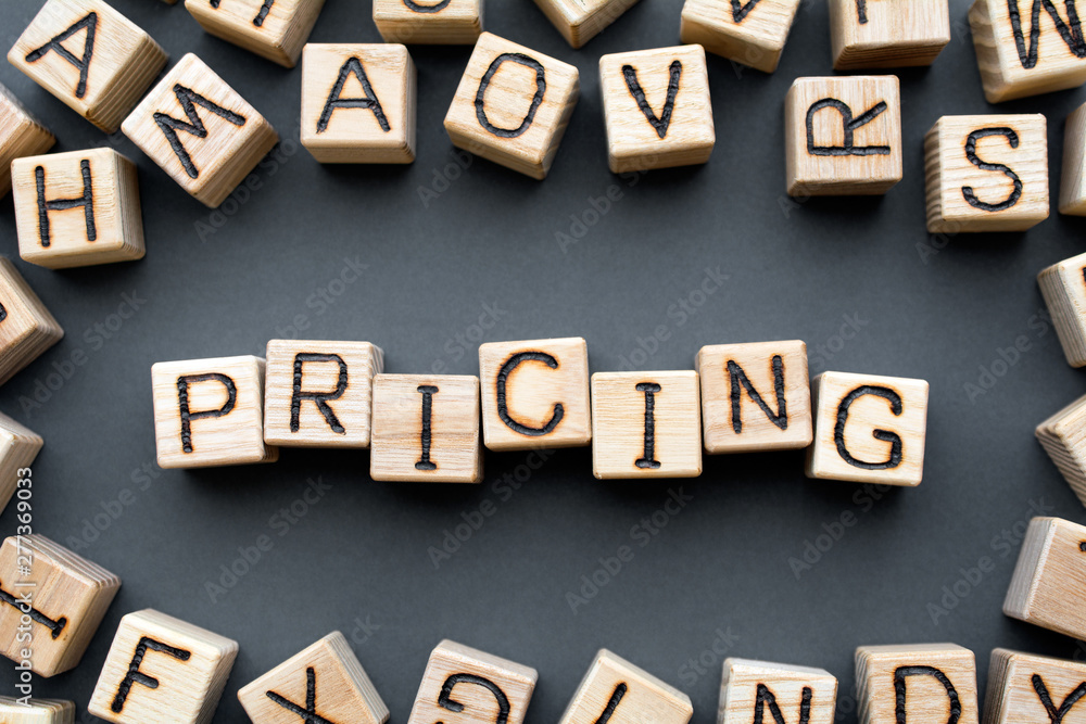 word pricing composed of wooden cubes with letters, Pricing strategies part of the business marketing plan concept, scattered around the cubes random letters, top view on gray background word pricing composed of wooden cubes with letters, Pricing strategies part of the business marketing plan concept, scattered around the cubes random letters, top view on gray background
