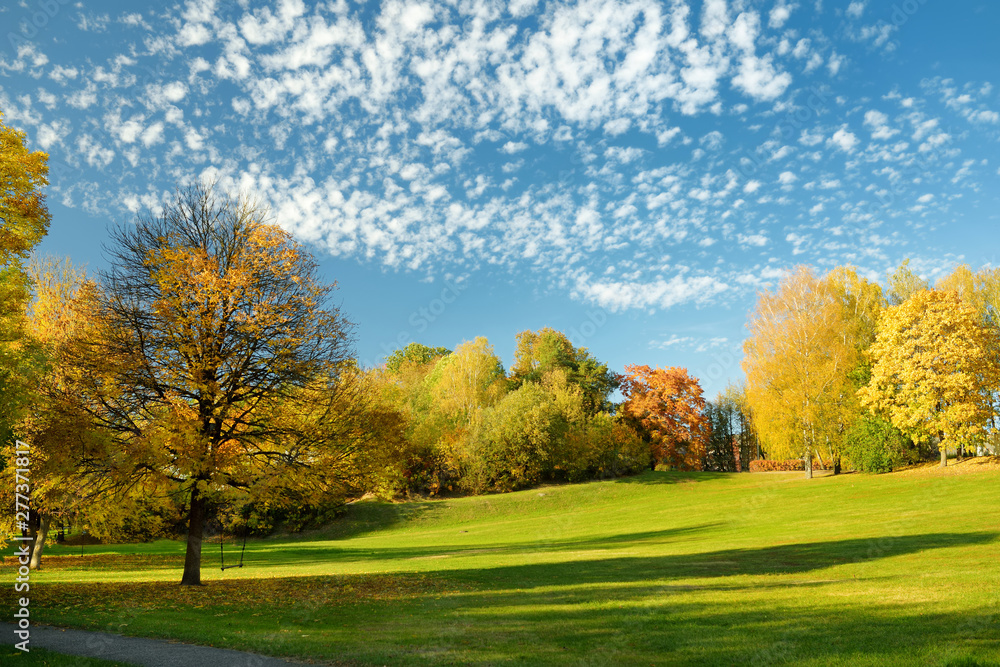 Colorful city park scene in the fall with yellow foliage. Beautiful autumn scenery in Vilnius, Lithuania. Colorful city park scene in the fall with yellow foliage. Beautiful autumn scenery in Vilnius, Lithuania.