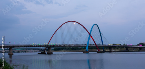 The Expo Bridge and the moon with colorful reflections in Daejeon, South Korea © NG-Spacetime