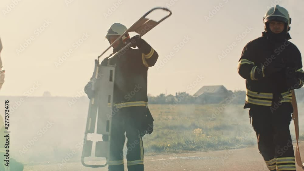 Rescue Team of Firefighters Arrive on the Car Crash Traffic Accident Scene on their Fire Engine. Firemen Grab their Equipment, Prepare Fire Hoses and Gear from Fire Truck. In Slow Motion Rescue Team of Firefighters Arrive on the Car Crash Traffic Accident Scene on their Fire Engine. Firemen Grab their Equipment, Prepare Fire Hoses and Gear from Fire Truck. In Slow Motion
