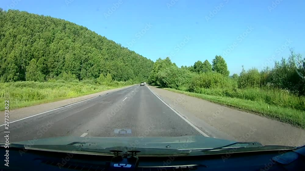 A view through the windshield of a car driving down the highway. A view through the windshield of a car driving down the highway.
