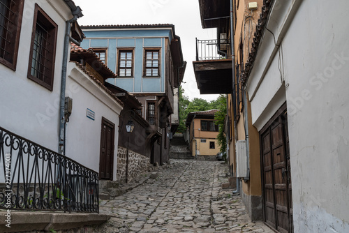 Fototapeta Naklejka Na Ścianę i Meble -   View of a narrow street in  historical part of  Plovdiv Old Town. Typical medieval colorful buildings. Bulgaria