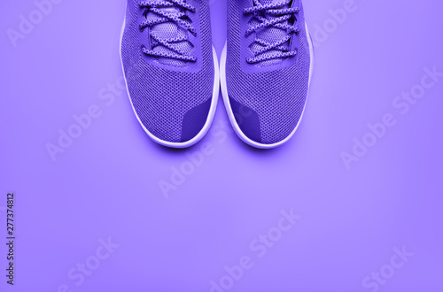 One Pair of purple sport shoes on color background