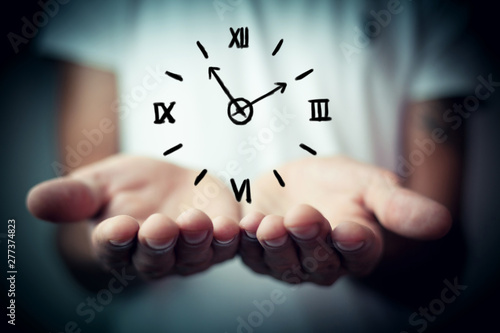 Businessman holding clock. Business time management