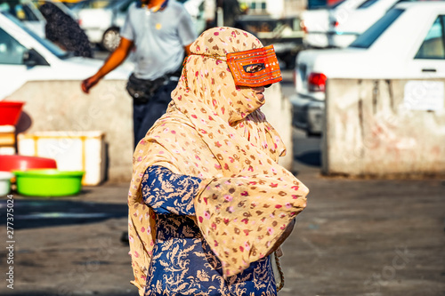 13/05/2019 Iran, Bandar Abbas, Hormozgan Province, .local woman dress colorful abayas and wearing peculiar masks, traditional Islamic dress of southern Iran photo