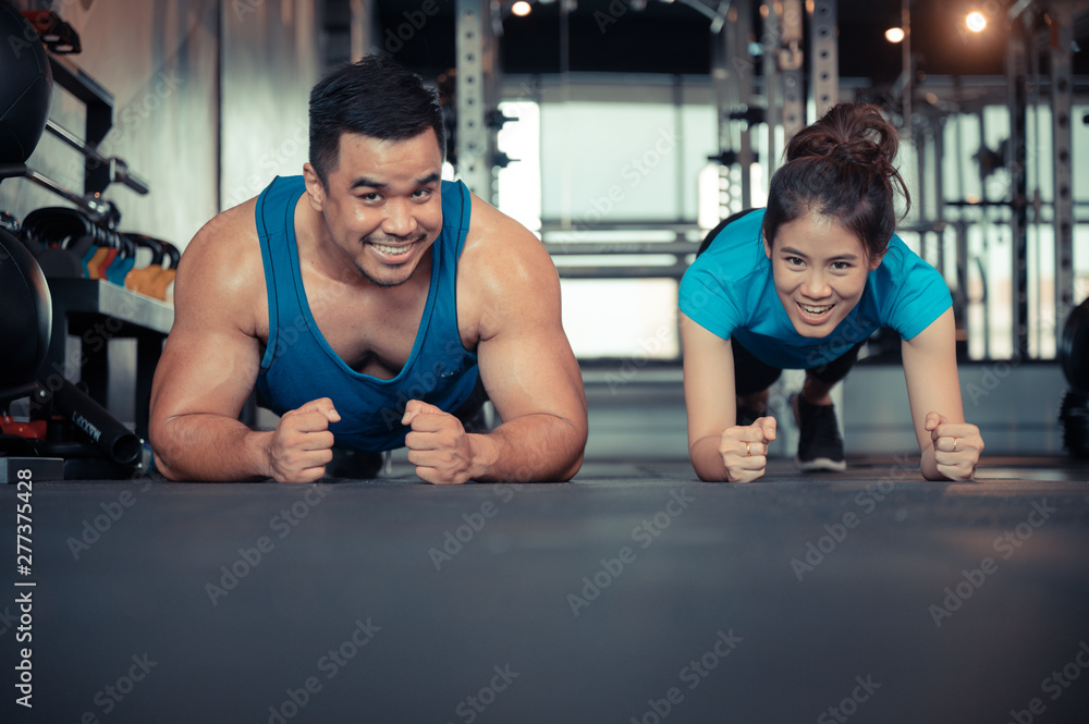 Couple exercising in the gym Couple exercising in the gym