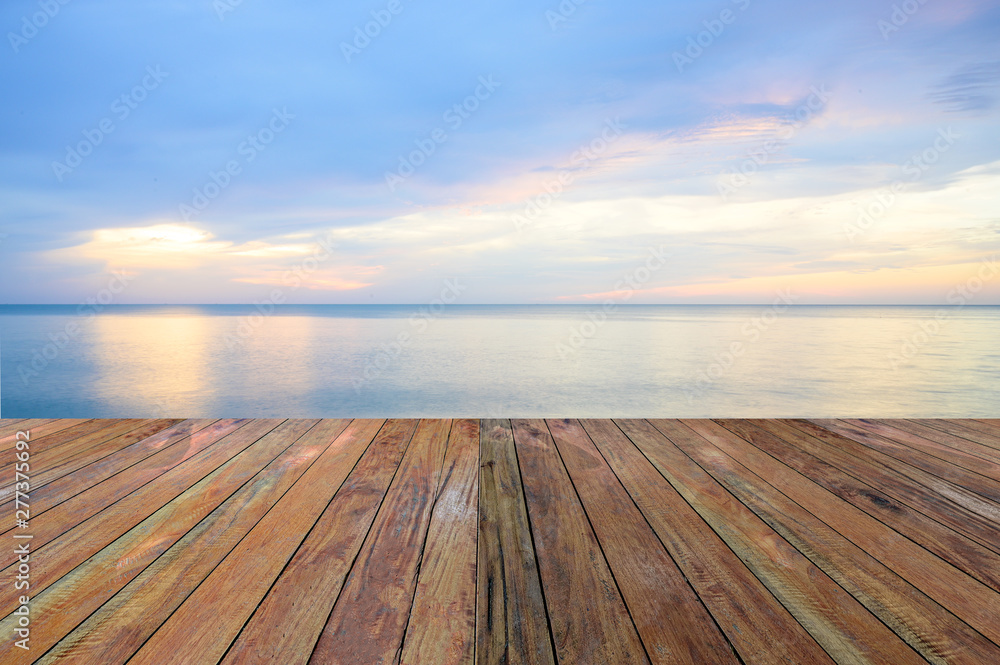 Empty wooden pier on calm sea morning background