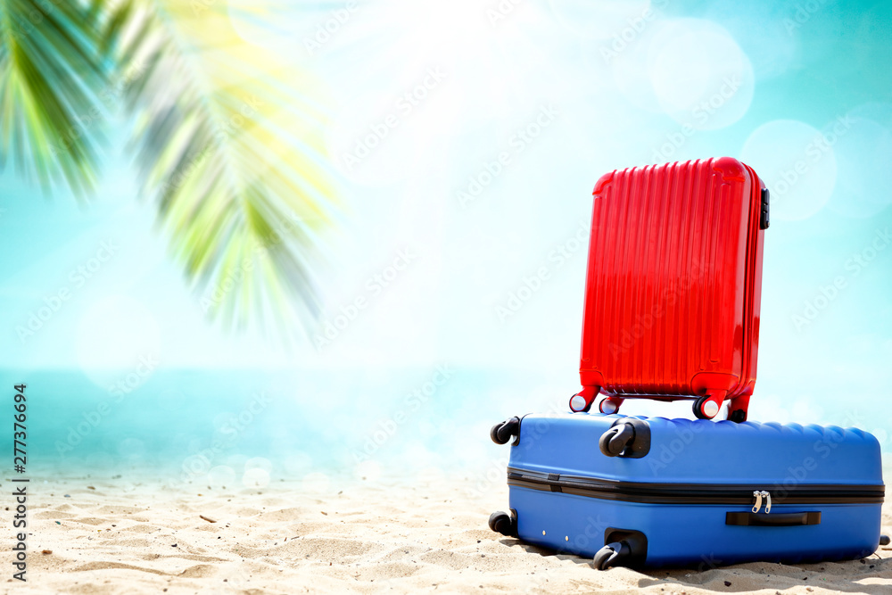 Summer suitcase on beach and free space for your decoration. 
