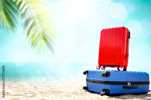 Summer suitcase on beach and free space for your decoration. 