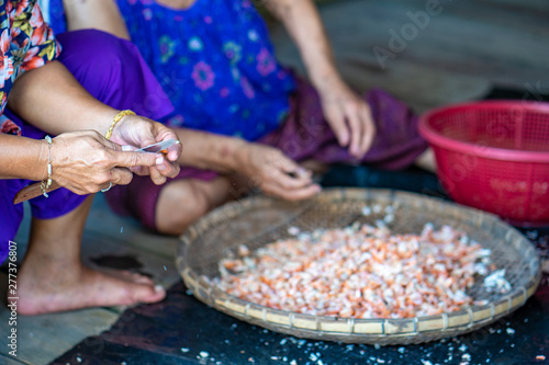 Fisherman female are preparing the dried shrimp for sales.