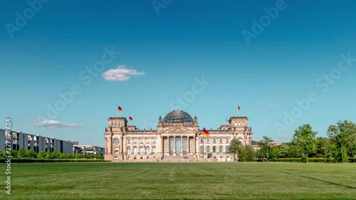 Berlin / Germany - July 2019: Time-lapse footage of the German federal parliament. Blue sky, clouds, german flag, Bundestag, summer / 4K Time Lapse Video