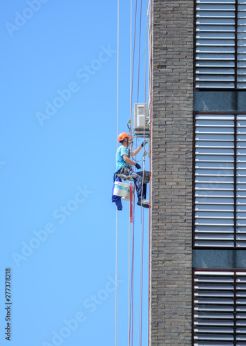 Workers at height making repairs on the facade